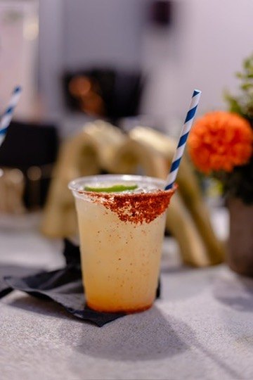 Spicy margarita with a Tajín rim and a striped straw